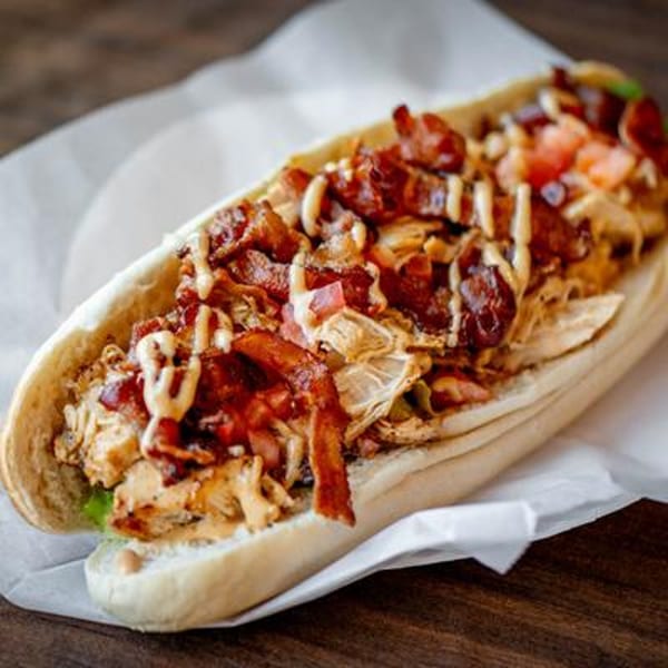 A close-up of a chicken bacon ranch sub from Buccieri's Pizzeria, on a wooden table.